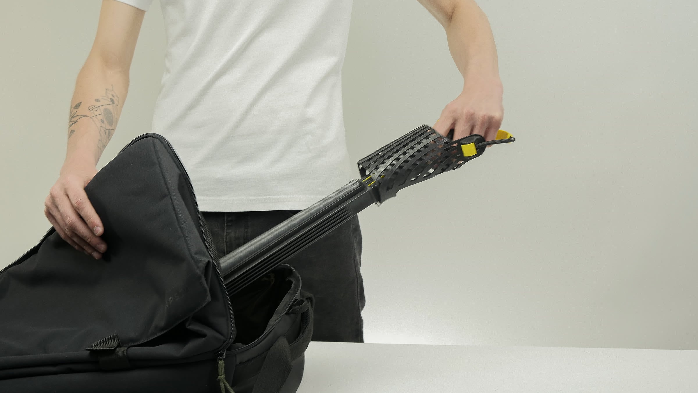 A full-size FoldingFins fin, folded, sliding into a backpack